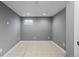 View of finished basement room that has tile floor, window and neutral paint at 4102 W Eastman Ave, Denver, CO 80236