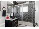 Modern bathroom with a glass bowl sink, mosaic tile accents, and a glass-enclosed shower at 4102 W Eastman Ave, Denver, CO 80236