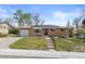 Charming brick home with solar panels, landscaped lawn, and inviting front entrance at 4102 W Eastman Ave, Denver, CO 80236