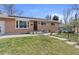 Lovely brick home featuring a tidy front yard, solar panels, and an inviting entrance at 4102 W Eastman Ave, Denver, CO 80236