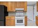 Kitchen featuring wooden cabinets and modern white appliances at 4102 W Eastman Ave, Denver, CO 80236