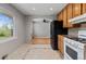 Efficient kitchen layout offering ample counter space, wooden cabinets and neutral tile at 4102 W Eastman Ave, Denver, CO 80236