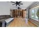 Spacious living room with wood floors, modern ceiling fans, and a decorative wood accent wall at 4102 W Eastman Ave, Denver, CO 80236