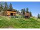 Outdoor area featuring a barn with horse stall and fenced enclosure at 16861 Wrangler Trl, Littleton, CO 80127