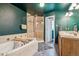 Well-appointed bathroom with a soaking tub, a separate shower, and a double sink vanity at 16861 Wrangler Trl, Littleton, CO 80127