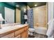Bathroom with tile shower-tub combination and wood vanity at 16861 Wrangler Trl, Littleton, CO 80127
