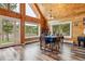 Dining room featuring wood floors, large windows, and rustic chandelier at 16861 Wrangler Trl, Littleton, CO 80127