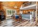 Inviting dining room with wood paneling, table set for four, and views of the exterior at 16861 Wrangler Trl, Littleton, CO 80127