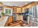 Bright kitchen with wood cabinets, stainless steel appliances, and a cozy breakfast nook at 16861 Wrangler Trl, Littleton, CO 80127
