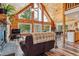 Cozy living room with fireplace and large windows offering scenic views at 16861 Wrangler Trl, Littleton, CO 80127