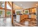 Open-concept living space with wood accents, dining table, and a modern kitchen at 16861 Wrangler Trl, Littleton, CO 80127