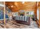 Spacious living room showcasing stone fireplace, high ceilings and wood floors at 16861 Wrangler Trl, Littleton, CO 80127