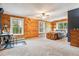 Spacious main bedroom with wood paneling, large windows, and cozy decor at 16861 Wrangler Trl, Littleton, CO 80127