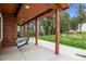 Inviting covered porch with a porch swing, perfect for relaxation and enjoying the outdoor scenery at 16861 Wrangler Trl, Littleton, CO 80127