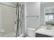 Bathroom with shower/tub combo, white tile and tree-themed shower curtain at 15372 E 117Th Ave, Commerce City, CO 80022