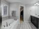 This spacious bathroom offers a tub, walk-in closet, and double vanity at 15372 E 117Th Ave, Commerce City, CO 80022