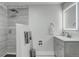 Bathroom with glass enclosed shower, rainfall shower head, and vanity with light up mirror at 15372 E 117Th Ave, Commerce City, CO 80022
