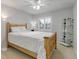 Comfortable bedroom offers a ceiling fan, window shutters, and decor shelving at 15372 E 117Th Ave, Commerce City, CO 80022