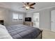 Relaxing bedroom with a ceiling fan and a view of the luxurious bathroom at 15372 E 117Th Ave, Commerce City, CO 80022