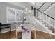 Dining room featuring hardwood floors, a chandelier, and modern marble patterned chair covers at 15372 E 117Th Ave, Commerce City, CO 80022