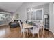 Open-concept area with dining table, hardwood floors, and comfortable gray sofa at 15372 E 117Th Ave, Commerce City, CO 80022