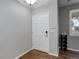 Entryway with light gray walls, wood-look floors, and white front door at 15372 E 117Th Ave, Commerce City, CO 80022
