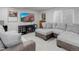 Comfortable living room featuring neutral tones, large windows, and a modern entertainment center at 15372 E 117Th Ave, Commerce City, CO 80022