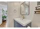 Bathroom features a modern vanity, mirror, and a view to the adjacent living space at 9401 Otis St, Broomfield, CO 80021