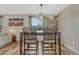 Bright dining area with stylish table, chairs, wood-look flooring and large window, perfect for Gathering meals at 9401 Otis St, Broomfield, CO 80021