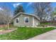 Well-maintained single-story home with an inviting lawn, brick-lined flowerbed and mature trees at 9401 Otis St, Broomfield, CO 80021