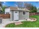 Charming shed with a white door and manicured landscaping at 9401 Otis St, Broomfield, CO 80021