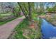 Tranquil stream alongside a walking path, surrounded by lush greenery at 9401 Otis St, Broomfield, CO 80021