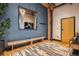 Entryway with wood floors, blue wall, rustic bench, and modern decor at 1792 Wynkoop St # 505, Denver, CO 80202