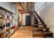 Hallway featuring open staircase, exposed pipes, storage cart, and hardwood flooring at 1792 Wynkoop St # 505, Denver, CO 80202