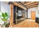 Hallway with hardwood floors, wooden beams, mirrored closet, and modern design at 1792 Wynkoop St # 505, Denver, CO 80202