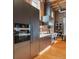 Modern kitchen with stainless steel appliances and exposed brick, creating a stylish culinary space at 1792 Wynkoop St # 505, Denver, CO 80202