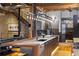 Modern kitchen featuring a large island, stainless steel appliances, and exposed brick, wood floors, and concrete stairs at 1792 Wynkoop St # 505, Denver, CO 80202