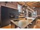 Spacious kitchen featuring brick accents, modern appliances, and an oversized island at 1792 Wynkoop St # 505, Denver, CO 80202