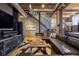 Open-concept living room with a large sectional sofa, media center, modern staircase, and exposed ductwork at 1792 Wynkoop St # 505, Denver, CO 80202