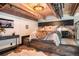 Bedroom with wood floors, exposed pipes and bed on a raised, wood platform at 1792 Wynkoop St # 505, Denver, CO 80202