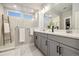 Stylish bathroom with double sinks, marble shower, and a unique decorative ladder at 6334 N Dayton Way, Denver, CO 80238