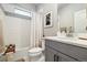 Clean bathroom featuring a tub with shower and modern vanity at 6334 N Dayton Way, Denver, CO 80238