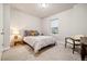 A cozy bedroom with neutral walls, plush carpet, and a well-lit window at 6334 N Dayton Way, Denver, CO 80238