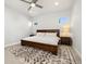 Bedroom with a ceiling fan, a dark wood bed frame, and a textured rug at 6334 N Dayton Way, Denver, CO 80238