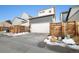 A modern two-story home with a white garage door, gray siding, and a well-maintained driveway at 6334 N Dayton Way, Denver, CO 80238