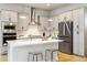 Stylish kitchen with stainless steel appliances, a center island with seating, and modern pendant lights at 6334 N Dayton Way, Denver, CO 80238