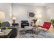 Stylish living room with a gray sofa, bright chair, and unique coffee table at 6334 N Dayton Way, Denver, CO 80238