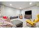 Comfortable living room with modern furniture, a large TV, and neutral decor at 6334 N Dayton Way, Denver, CO 80238