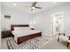 Bright main bedroom features a ceiling fan, a wood bed frame and a ensuite bathroom at 6334 N Dayton Way, Denver, CO 80238
