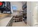 Organized walk-in closet features shelves, clothing racks, and access to the shower at 6334 N Dayton Way, Denver, CO 80238
